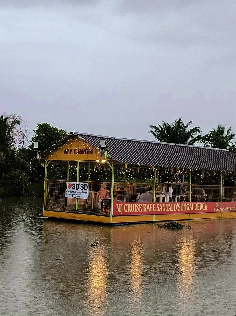 MJ Cruise menyusuri Sungai Derga waktu senja dengan lampu hiasan
